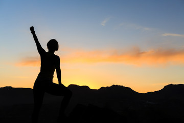 Wall Mural - Woman climbing success silhouette in mountains sunset
