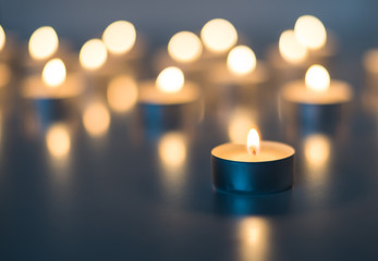 Flame of many candles burning on the background blue color