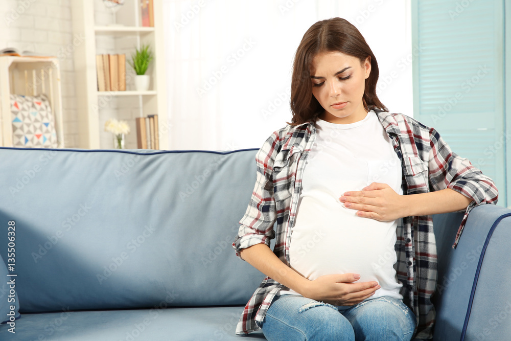 Young pregnant woman feeling bad at home