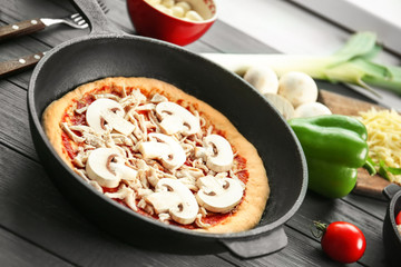 Sticker - Unbaked pizza in pan on wooden table