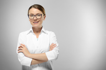 Wall Mural - Young woman on grey background