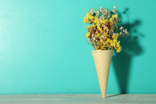 Dry Yellow Flowers In Waffle Cup On A Blue Background.
