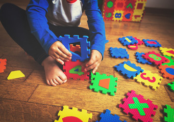 Poster - little girl playing with puzzle, early education