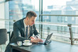 © tadeas - Young businessman sitting in office