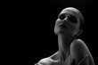 © tugolukof - happy luxury woman model with professional makeup on black background monochrome