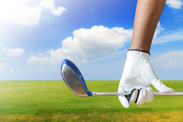 Golf player holding a golf club in golf course