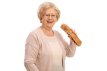 Sticker - Cheerful elderly woman having a sandwich