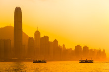 Hong Kong Evening Sky / Beautiful Hong Kong Cityscape View At Orange Sunset Light With Two Ships, Tall Buildings And Peak Mountain (copy Space)