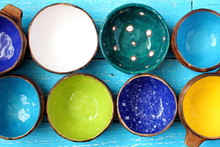 Many Different Bright Multicolored Ceramic Bowls And Cups Handcrafted. Top View. View From Above. Background Texture