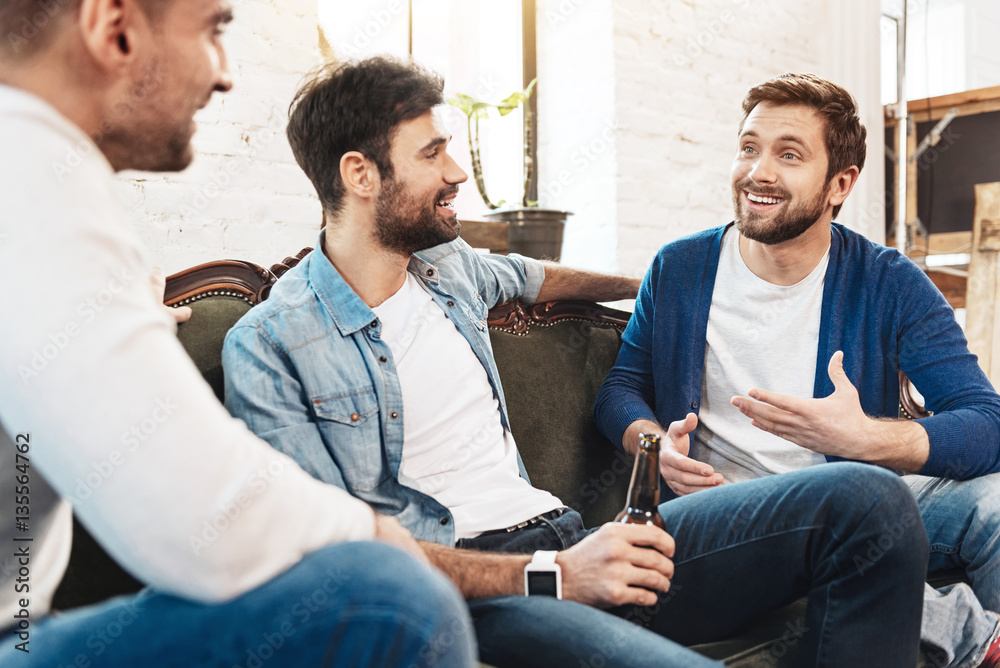 Nice joyful men chatting with each other