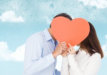 Canvas Print - Romantic couple hiding their face behind heart