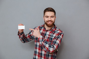 Wall Mural - Happy man standing with copyspace business card