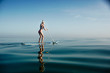 © Julian Walter - Female paddle boarding on calm water