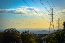 Sunset In The Mountains Over Power Lines With Downtown Los Angeles Skyline Ithe The Background.