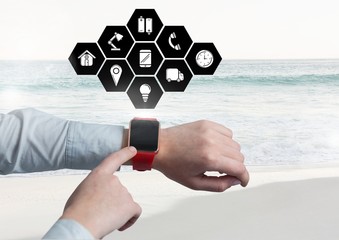 Hands using smartwatch with digitally generated icons