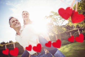 Man giving piggyback ride to woman in park