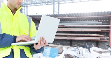 Poster - Male architecture using laptop at construction site