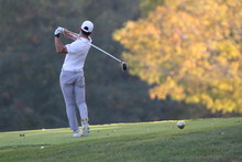A Muscular Golfer Tees Off With His Driver On An Autumn Day In New England With The Vermont Foliage As Bright As Can Be
