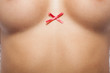 Woman breast with little red bow.