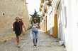 © Monkey Business - Couple on holiday walking in Ibiza streets with a guidebook