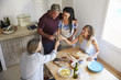 © Monkey Business - Two couples preparing dinner make a toast, elevated view