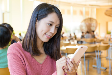 Wall Mural - Woman use of mobile phone at restaurant