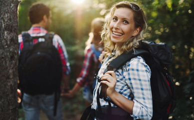 Wall Mural - beautiful woman and friends hiking in forest