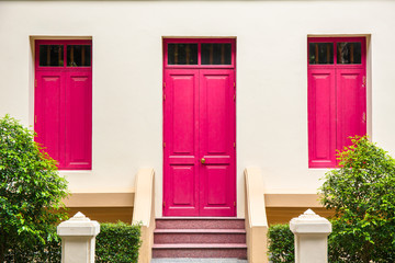 pink Door , pink window on Cream Wall on pink staircase with sma