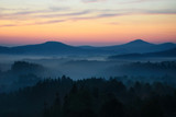 Fototapeta Na ścianę - Sunrise in Bohemian Switzerland with typical foggy atmosphere, Czech republic