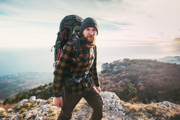 bearded man backpacker hiking in mountains travel lifestyle concept adventure active vacations outdo