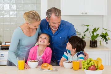 Happy family having breakfast in kitchen