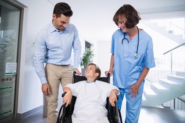 Canvas Print - Man and doctor interacting with disable boy