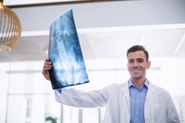 Wall Mural - Doctor standing with x-ray in corridor