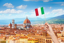 Hand With Italian Flag And Cityscape Of Florence