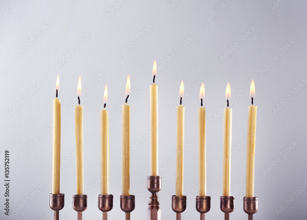 Menorah with candles for Hanukkah on light background, close up