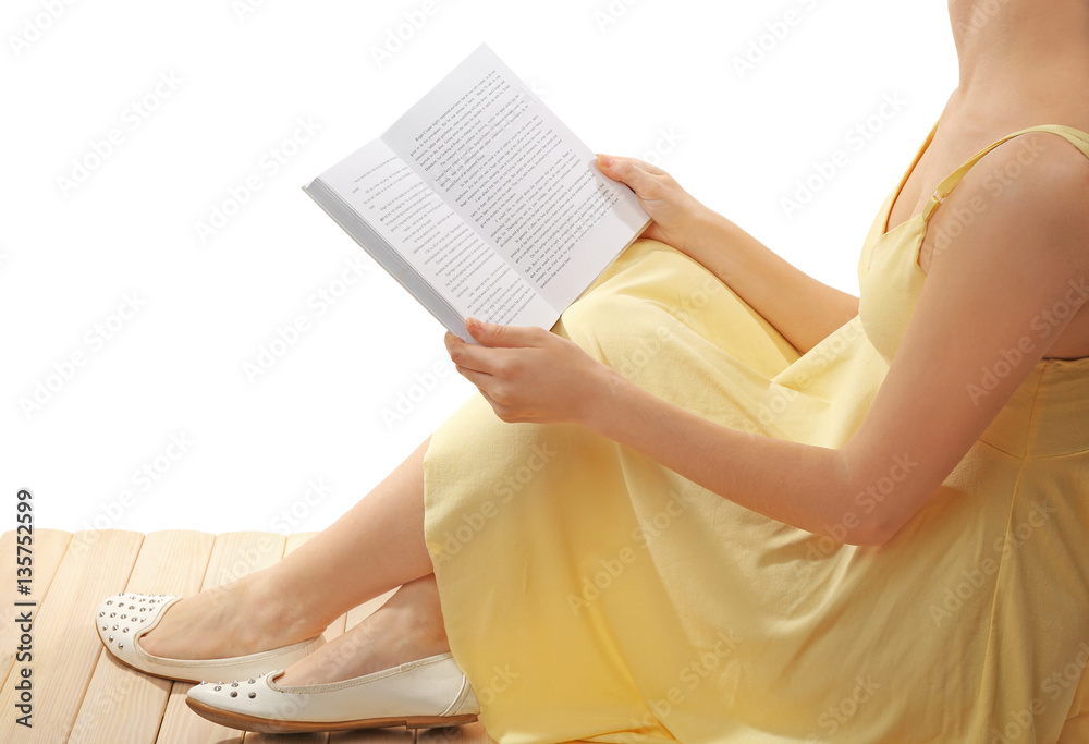 Beautiful young woman reading book on white background