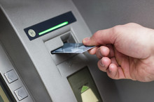 Hand Of A Man With A Credit Card, Using An ATM. Man Using An Atm Machine With His Credit Card.