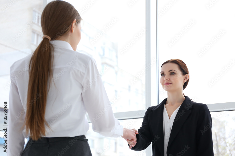 Job interview concept. Human resources manager shaking woman's hand, closeup