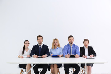 Wall Mural - Human resources team sitting at table on white background