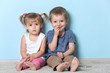 © Africa Studio - Cute funny children sitting near wall at home