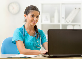 Wall Mural - Medical doctor woman working with computer. Isolated over white background.