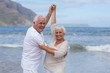 © WavebreakMediaMicro - Senior couple having fun together at beach