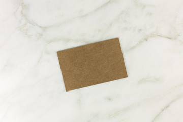 Wall Mural - Brown kraft card on white marble texture