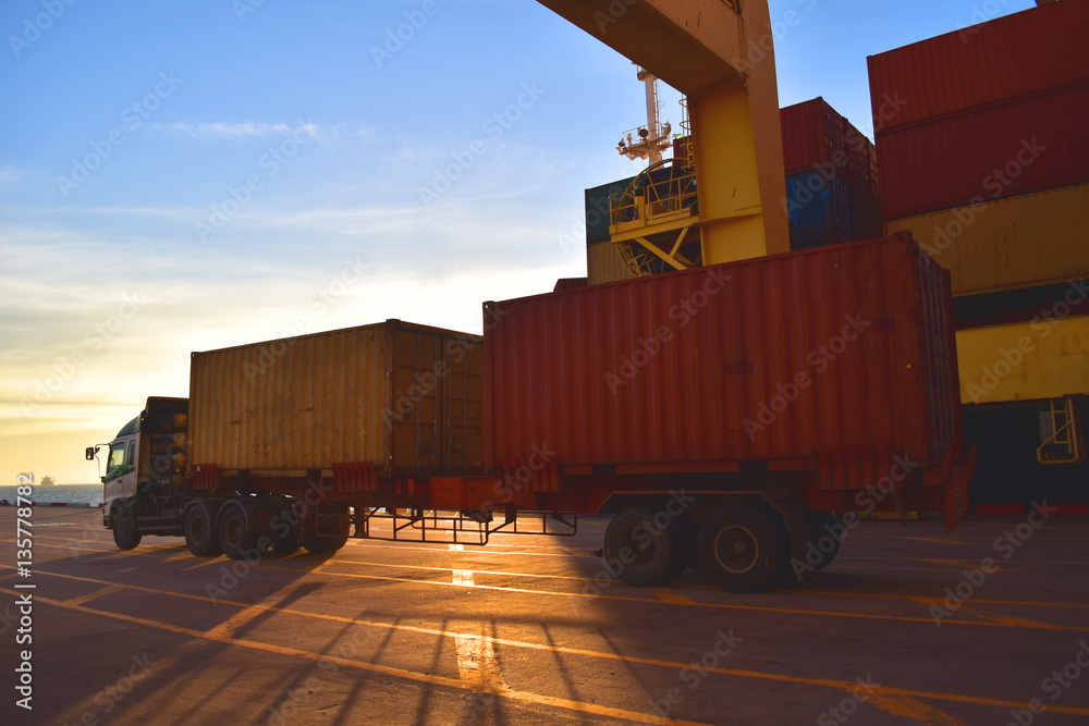 Container truck loaded with two containers at port with big vessel on ...