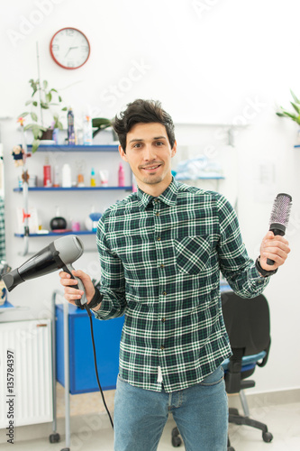 Fotografie, Obraz Professional male hairdresser with comb and hairdryer at hair salon