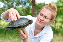 Pretty Blond Woman Holding A Turtle