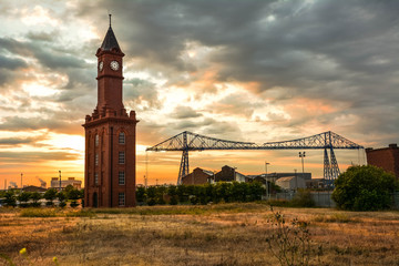 ld bell tower and the transporter bridge, middlesbrough. a gondola carries vehicles across the river