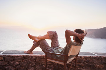 Enjoying life. Young man looking at the sea, vacations lifestyle concept