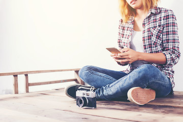 Wall Mural - Young beautiful hipster woman with an old retro camera.