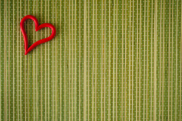 Valentine heart on green wooden mat, view from the top.